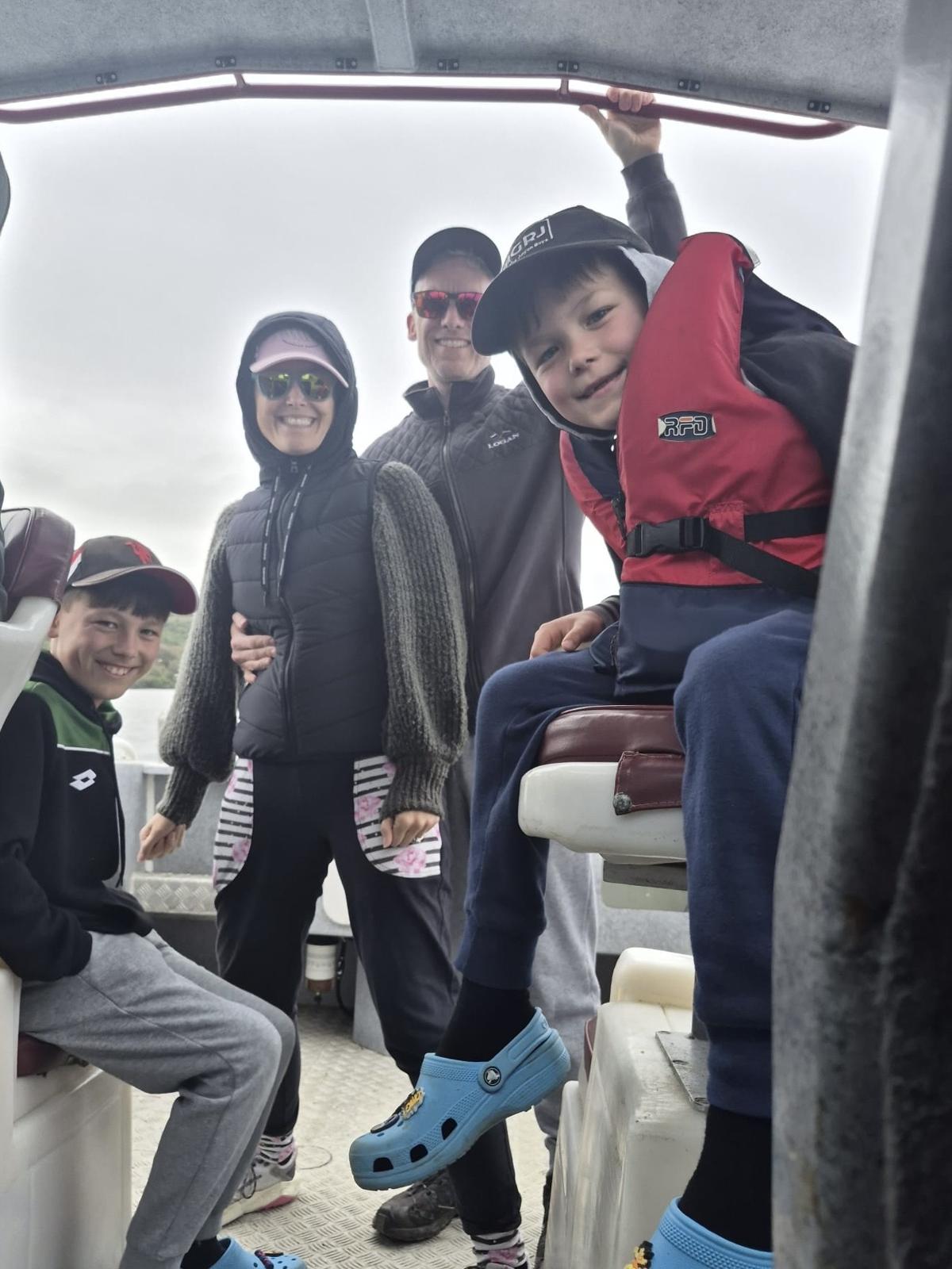 Janeen outdoors with her family on a boat